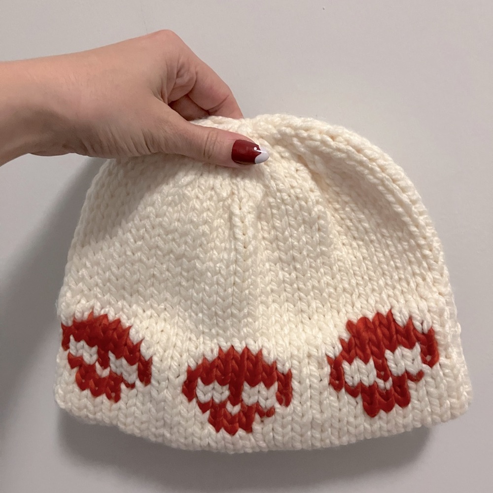 New cream beanie with orange skulls